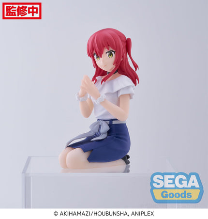 Ikuyo Kita PM Perching figure, side view of white frilled blouse and navy skirt